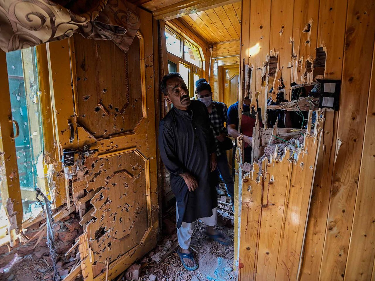 A local resident look inside a damaged room at the site of a gun-battle in Srinagar, Indian controlled Kashmir, Sunday, April 10, 2022. Indian government forces killed two suspected rebels in disputed Kashmir on Sunday, officials said. This project documents ongoing unrest in the long-disputed region of Kashmir, dating back to 1947, when India and Pakistan gained independence from Britain. Both nations claim Kashmir in its entirety, and each administers a portion of the region. In Indian-administered Kashmir, rebels have been fighting Indian rule for decades, seeking to unite the territory, either under Pakistani rule or as an independent country. India says that Pakistan supports armed insurgency in Kashmir. Pakistan denies the charge, saying it provides moral and diplomatic support only.
